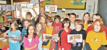 Grade 3-4 Falcons (Mrs. Carolyn Schwantes) during Career Day at Pine Mountain Learning Center shows their copies of The Mountain Enterprise and told their own stories. [Not shown, Grades 5-6 Quails, taught by Mrs. Emily Lee. The Quails interviewed each other and discussed the Who, What, Where, When, Why and How questions of journalism.]  