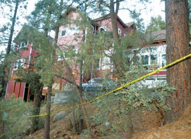 The house on Symonds Drive in Pine Mountain where a man was shot Friday, July 20 is encircled by crime scene tape. [Hedlund photo for The Mountain Enterprise]
