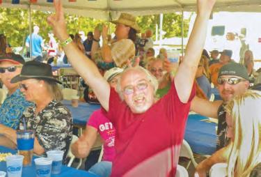 The dining tent hosted bands, making fans very happy. This group was enjoying the Mad Dogs. [Hedlund photo for The Mountain Enterprise]