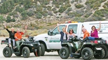 Southern Kern Search and Rescue team members (in orange shirts, l-r) Jim Stolting and Mike Parker were the happy recipients of two brand new Polaris 550 &quot2-up" quads from the South West Health Care District board (l-r) Michelle Neville, Toby Brault, Chris Pinnella and Barbara Murray. 