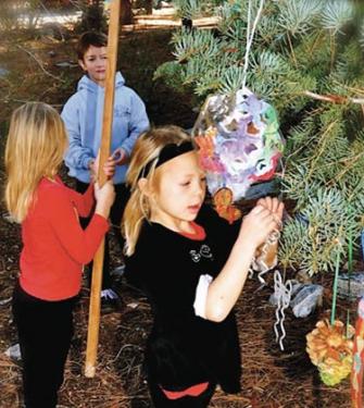 Pine Mountain Learning Center students decorating tree in Pine Mountain Village December 8, they won first prize. A present of smaller classes was given to Frazier Park School families this month. [Denise Nelson photo]
 
