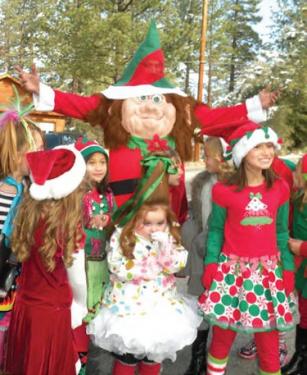 Elves and reindeer dogs gathered to march with Santa through Pine Mountain Village Saturday, Dec. 15. In center, Mazie Lynn Underwood, 4 as 
Cindy LuLu from The Grinch movie. [Denise Nelson photo]