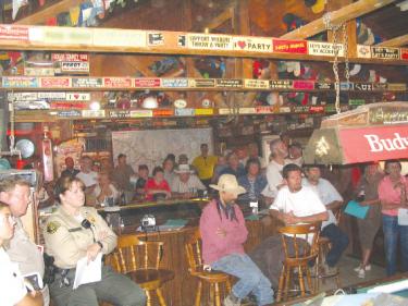Residents from around Highway 33 gather in a local bar with firefighters and law enforcement for the Zaca fire update.

