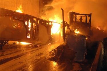 [AP photo] Big rig trucks ablaze at entrance to tunnel on Interstate 5, in the Newhall Pass, Friday night, Oct. 12.





















