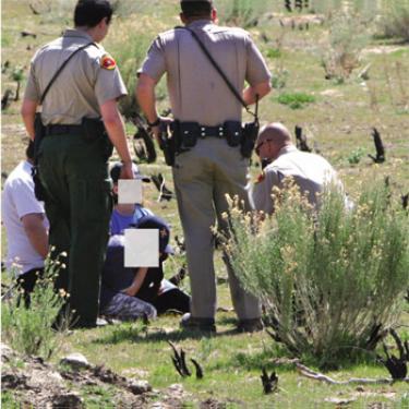 Sheriff?s deputies, a California Highway Patrol officer and a family friend speak with the two youngsters after they were located in the hills east of Interstate 5. Their identities are shielded.


