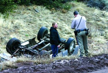 Jamie Jensen gives the facts to CHP officer Todd Birmingham about his single vehicle accident on Mil Potrero Highway Thursday morning, Feb. 8.
