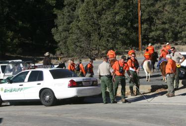 Sheriff?s deputies and members of Southern Kern Search & Rescue assemble in Lake of the Woods on Wednesday before heading into the hills to look for evidence related to skeletal remains found Tuesday. [Photos by Gary Meyer, The Mountain Enterprise]













