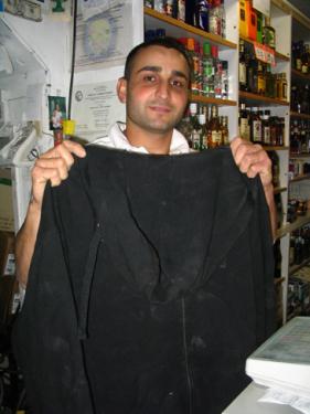 Ray Akari, owner of Mountain View Market, holds the sweatshirt worn by the thief who attempted to steal liquor from his store on March 27. [Meyer photo]


