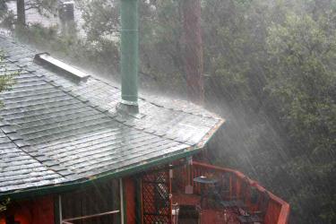 A Sunday downpour pounds a house in Pine Mountain. [Katy Penland photo]




