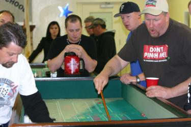 Stickman Jason Jens (right) keeps the action rolling at the Casino Night craps table. The high school Booster Club’s annual fundraiser supports athletic programs and the drumline.