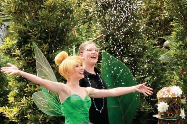 Tinker Bell throws a pixie dust salute to Zoe P, winner of the “Design a Fairy House” contest at Epcot.