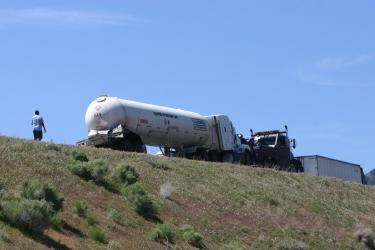 A big rig tanker hauling liquefied petroleum gas was apparently rear-ended by the freight truck stopped on the overpass, to the north. [Photo by Gary Meyer, The Mountain Enterprise]