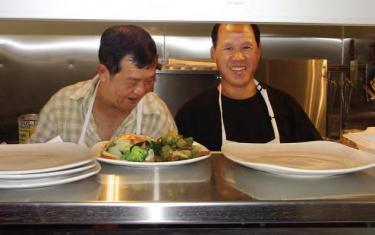 A crowd was on hand throughout the lunch hour  and happy cooks (l-r) Vinh and Lee were busy bees all day and evening.