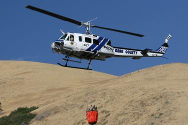 Chuck Noble of Lebec took this photo of a Kern County helicopter taking a load of water to douse the median fire near Fort Tejon on the Interstate 5 Tuesday afternoon about 5 p.m.