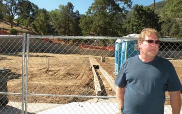 Architect Max Williams shows some of the drain structure being built into the library site.