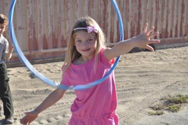 Third grader Saundra Farringer plays with a hula hoop and proves that the first day of school isn’t as totally scary as these two girls appear (next photo) to think. They look a little unsure.