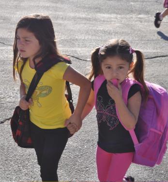 The first day of school isn’t as totally scary as these two girls appear to think. They look a little unsure of this new adventure.