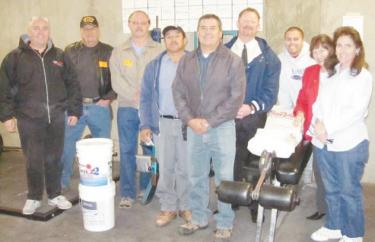 Assembling in the room to be repaired: Harry Spyrka of Ace Hardware; Project coordinator Larry Skiba; Rotary President-Elect Dennis Turner; Jose Molina and school district maintenance director Fernando Nieto; FMHS Principal Dan Penner; FMHS Coach Steve Aguilar; Rotary Past President Mitch Wood and Kathy Parker of Alpine Lumber & Mercantile. 