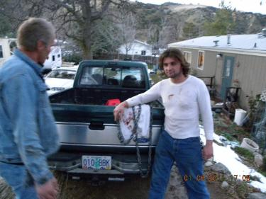 John Hughes, left and newphew Chris Huges used this 4-wheel drive Ford Ranger and the tow chain shown here to pull the door off the crushed cab of the burning big rig to get driver Philip Frear out of the flames and into safety. The men are shown here in front of their construction work site in Los Padres Estates Friday, still wearing the clothes they had on during the rescue. [photo courtesy of Barbara Hughes] See video interview below.