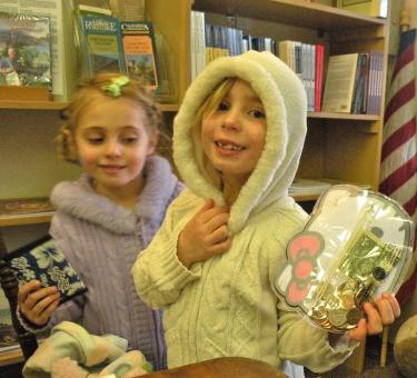 Hannah and Katelyn Bernards dress up and bring their tooth fairy money to the museum to visit, chat, color big pictures of flying condor and select new creepy crawlies for their collection.
