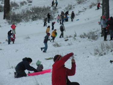 The lure to snowplay in the Los Padres National Forest near Frazier Park is obvious. Families find affordable fun sliding down hills and laughing in a carefree old-fashioned frolic. [Hedlund Photo/The Mountain Enterprise]