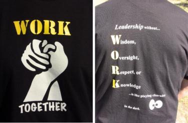 Most  the teachers wore T-shirts with a Work Together logo. On the back of their shirts was an acrostic slogan: Leadership without Wisdom, Oversight, Respect or Knowledge...is like playing charades in the dark.