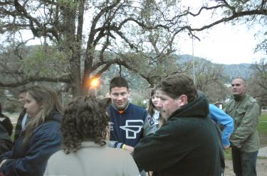 Antonio Saenz (center) and teacher Chuck Mullen (right, dark jacket) at meeting of parents, teachers and students in Frazier Mountain Park May 16 to consider how to take action to save sports programs in El Tejon Unified School District. [Tony Levesque photo]