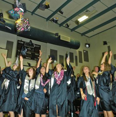Tossing the mortarboards into the sky after the ceremony is an honored tradition. [Hedlund Photos]