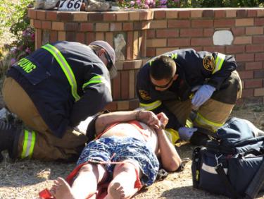 Station 57 personnel provide medical aid to the hit and run suspect on Circle Drive. [photo by The Mountain Enterprise]