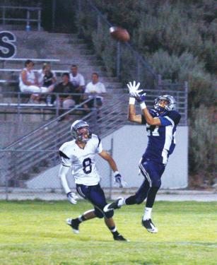 Forest Pohl, #8 defends a leaping catch by Marquis Hunt in a Frazier Mountain Falcon football team exhibition game on August 26.