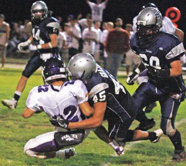 Frazier Mountain High School Falcon defensive tackle Ben Grajeda (45) takes down a Vasquez runner. See more on pages 16 and 28.