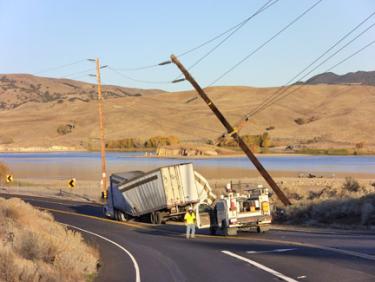 A crumpled big rig sits on Highway 138 after colliding with a power pole, shutting down the roadway in both directions for most of Thursday, Dec. 8. [photo by The Mountain Enterprise]