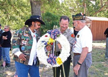 Simba Wiley Roberts, Kern County Sheriff Donny Youngblood and three-time VFW commander of the local VFW chapter, Wilford Bummer present wreath during emotional Memorial Day ceremony at the Cody Prosser Memorial on Monday, May 28 in Frazier Park.

