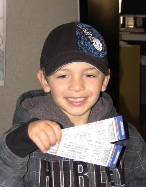 Four-year-old Evan Stevens shows his tickets. He printed a letter about the amazing fun tricks the Globetrotters can showcase.
