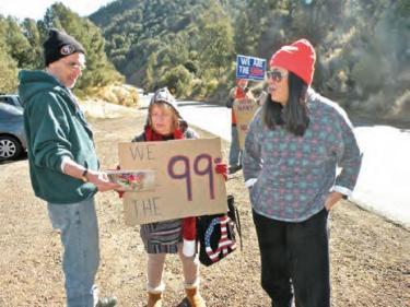 Candidate Laura Molina (in red cap) talks with Occupy demonstrators. Laura Molina says if California got back more of what is sent to Washington D.C. in federal taxes, that money could help this state fund its schools.
[Hedlund photo]