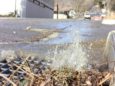 Water running down Mt. Pinos Way, east of Frazier Park Market. [photo by The Mountain Enterprise]