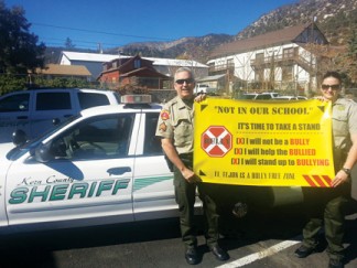 Sergeant Mark Brown and Deputy Rebecca Karr support the Anti-Bullying ‘Time to Take a Stand’ campaign in Mountain Community Schools.  [photo by Scott Robinson]