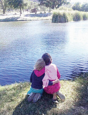 Two children enjoying the beauty of the Frazier Park pond in 2014, a year before residents noticed the water level falling.