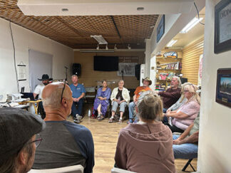 Pastors addressing each other at the community meeting  