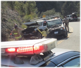 Firefighters and CHP officers managed the accident scene near the top of the S-curves in Pine Mountain Club on Wednesday, Sept. 7. [photo by Patric Hedlund, The Mountain Enterprise]