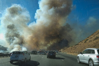 By 4:30 p.m. on 9/11 the Route Fire (that started just before 3 p.m.) had jumped the Interstate-5 freeway and blocked traffic for over 4 hours.  [photo by Charlie Hall of Pine Mountain Club]