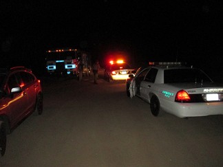 Kern County sheriff's deputies meet with fire station 57 personnel on Saturday evening, October 19 at about 9 p.m. regarding a medical emergency which turned out to be a fatality at a campground north of Cuddy Valley. [photo by Gary Meyer, The Mountain Enterprise]
