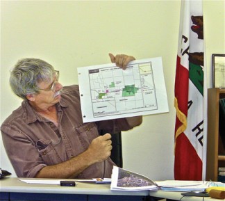 Dave Warner, consultant to the water planning group, shows areas that have the option to be  part of the annexation if FPPUD decides to serve a larger area. [photo by Patric Hedlund]