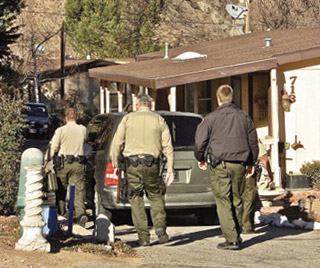 Deputies armed with a search warrant approach the home of Donald Corrigan on Louise Way in Los Padres Estates, January 1 to search for evidence of bomb-making. [photo by Patric Hedlund]