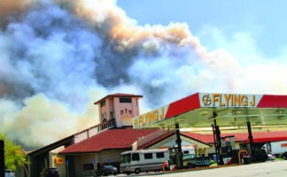 The Grand fire rages across the hillsides behind the Flying J truck stop. [Jeff Zimmerman photo]