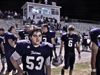 Taylor Mason #53, Matthew Regan #6 and the Falcon team, weary, dirty and hurt after the first home football game of the season [photo by Patric Hedlund]