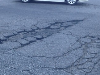 One of the giant pot holes near the interface between Kern County and Los Angeles County at Frazier Mountain Park Road and  Peace Valley Road near Flying J in Lebec. [special to The Mountain Enterprise from Nancy Rogers]