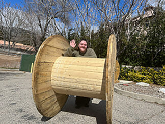 The Mountain Enterprise Office Manager Samantha Smith with one of the giant cable spools.