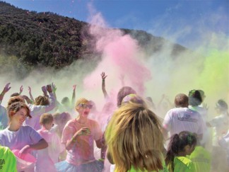 Top and right, At the grand finale celebration of the “Color the Mountain  5k Run” fountains of color soared into the air.  [photo by Patric Hedlund]