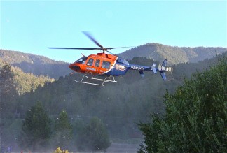 The Hall medevac helicopter aloft, taking the cyclist for medical care.[Patric Hedlund photo for The Mountain Enterprise]